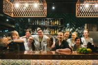 a group of people standing behind a bar at Original Sokos Hotel Vaakuna Rovaniemi in Rovaniemi