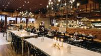 a restaurant with tables and chairs and a bar at Original Sokos Hotel Vaakuna Rovaniemi in Rovaniemi