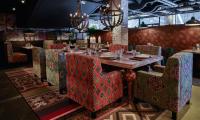 a dining room with a wooden table and chairs at Original Sokos Hotel Vaakuna Rovaniemi in Rovaniemi