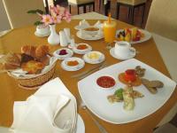 a table with a plate of breakfast food on it at Rajarata Hotel Anuradhapura in Anuradhapura