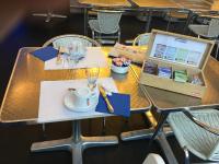 a table with a cup of tea and a laptop on it at Les Thermes in Dax