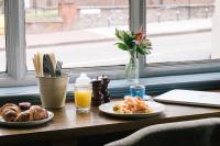 a table with two plates of food and a window at The Brewers Inn in London