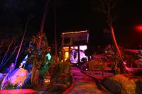 a garden at night with a house with lights at Moonstone Studio in Haad Rin