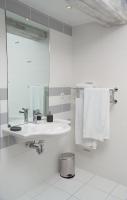 a bathroom with a sink and a mirror and towels at Côte d&#39;Opale - La Ferme des Saules in Millam