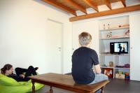 two people sitting on a table in a living room at Holiday home Het Zeugekot in Beveren