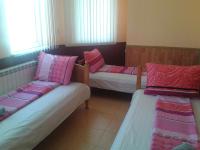 A bed or beds in a room at Osogovo Rooms