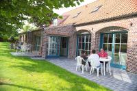 a group of people sitting at a table on a patio at Côte d&#39;Opale - La Ferme des Saules in Millam