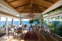 a dining room with a chandelier and the ocean at Donatela Resort and Sanctuary in Panglao