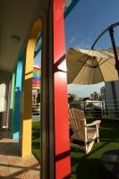 a chair and an umbrella next to a building at Sweet Rainbow B&amp;B in Hualien City