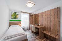 a small bedroom with a bed and a desk at City Rooms Wels - contactless check-in in Wels