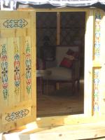 a wooden room with a chair and a window at Le Mas Nomade in Callian