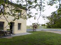 a building with a picnic table next to a street at Modern Holiday Home in Florenville with Garden in Chassepierre