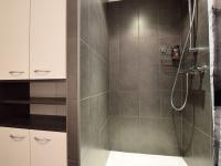 a bathroom with a shower with a glass door at Modern Holiday Home in Florenville with Garden in Chassepierre