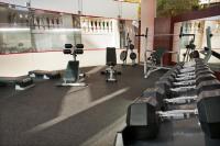 a gym with rows of exercise bikes and weights at Herods Palace Hotels & Spa Eilat a Premium collection by Fattal Hotels in Eilat