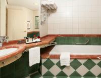 a bathroom with a tub and a sink at Herods Palace Hotels & Spa Eilat a Premium collection by Fattal Hotels in Eilat