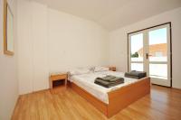 Łóżko lub łóżka w pokoju w obiekcie Apartments Renato