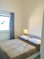 Postel nebo postele na pokoji v ubytování Apartments Suzana