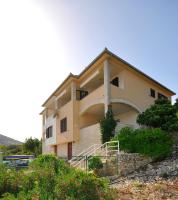 a building on top of a hill with at Apartments Val in Vinišće
