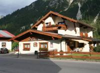 a building with a balcony on the side of a mountain at Haus Guentli in Mittelberg