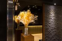 a couple of vases with yellow flowers in a room at Chance Hotel in Taichung