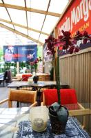 a table with a vase with a flower in it at Ranna Villa & FREE PARKING in Pärnu