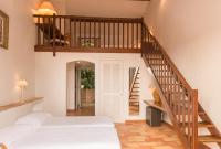 a room with a bed and a stair case at Saint-Vincent in Saint-Tropez