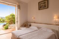 a bedroom with a bed and a view of a pool at Saint-Vincent in Saint-Tropez