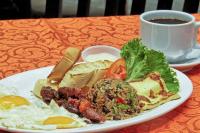 a plate of food on a table with a cup of coffee at Balmoral Hotel San José CR, Historic District in San José