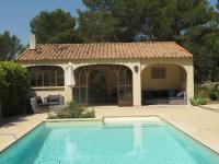 a swimming pool in front of a house at L&#39;Oustau de Bigatié in Lambesc