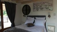 a bedroom with a bed with white sheets and a mirror at Bastide De Mazan in Riez