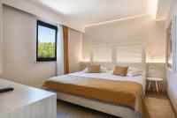Ein Bett oder Betten in einem Zimmer der Unterkunft Villas Bellevue Plava Laguna