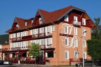 a large building with a sign that says hotel at Logis Hotel Des Bains in Gérardmer