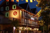 a building with a clock on the side of it at Logis Hotel Des Bains in Gérardmer