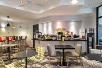 a restaurant with tables and chairs and a counter at Citadines Bastille Gare de Lyon Paris in Paris