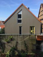 a house with a yellow door and some stairs at Blackbird´s Nest in Wiesenbronn