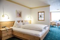 A bed or beds in a room at Hotel Kristall