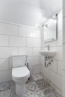 a white bathroom with a toilet and a sink at Florella Marceau Apartment in Cannes