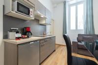a kitchen with a sink and a microwave at Florella Marceau Apartment in Cannes