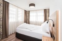 Łóżko lub łóżka w pokoju w obiekcie Adler Resort