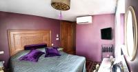 a bedroom with purple walls and a bed with purple pillows at Merial Hotel Sultanahmet in Istanbul