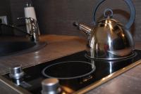 a tea kettle sitting on top of a stove at Myappartepinal in Épinal