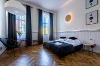 Posteľ alebo postele v izbe v ubytovaní apartamenty kamienica