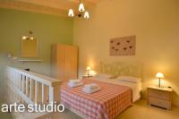 A bed or beds in a room at Suites Pierion Musses