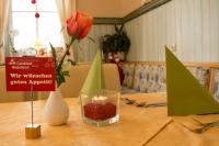 a table with a vase with a flower and a candle at Gasthof Waldwirt in Russbach am Pass Gschütt