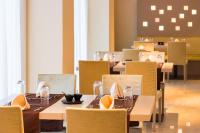 a dining room with tables and chairs and a table set for dinner at Radisson Blu Hotel N'Djamena in NʼDjamena