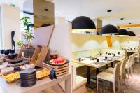 a dining room with tables and chairs with plates at Radisson Blu Hotel N'Djamena in NʼDjamena