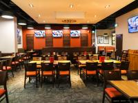 a dining room with tables and chairs and televisions at Americana Waterpark Resort & Spa in Niagara Falls