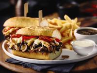 a sandwich on a plate with french fries and sauce at Americana Waterpark Resort & Spa in Niagara Falls
