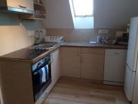 A kitchen or kitchenette at Pécsely apartman