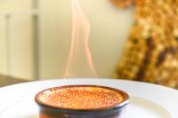 a close up of a cup of sauce on a plate at Logis Hôtel Restaurant des Corbières in Lagrasse